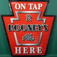 Rooney’s Ale “On Tap Here” Embossed Metal Keystone Bar Sign